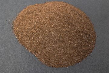 dry seasoning black ground pepper on a gray background