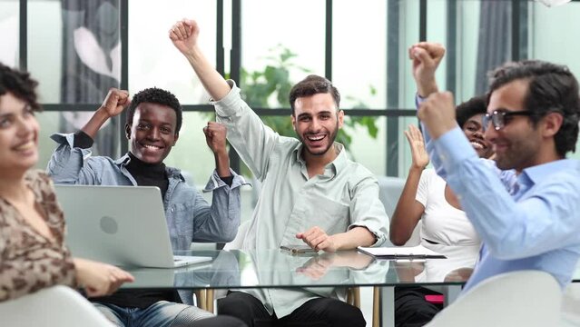 Best team ever. Portrait of extremely happy multinational coworkers are standing in office and screaming while expressing gladness.