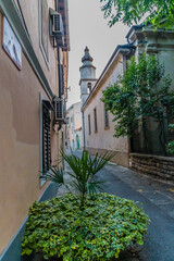 A view down a street towards the church in the town of Izola, Slovenia in summertime