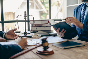 Male lawyer or judge consulting or discussing contract documents with clients Businessmen in office meeting with new clients sharing legal advice explaining legal process - obrazy, fototapety, plakaty