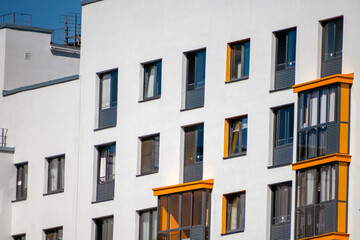 Fototapeta premium Fragment of the facade of a multi-storey residential building on a summer day