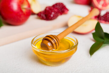 Rosh hashanah, jewish holiday, concept: honey, apple and pomegranate with cutting board, close up