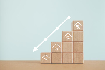 Home loan, mortgage and buy a real estate concept. Wooden cube blocks with percent inside house icon , down arrow including copy space