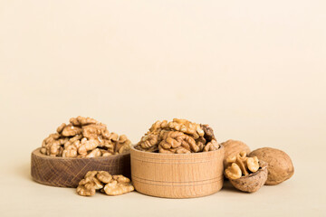 Fresh healthy walnuts in bowl on colored table background. Top view Healthy eating bertholletia concept. Super foods