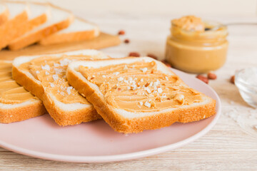 Peanut butter sandwiches or toasts on light table background.Breakfast. Vegetarian food. American cuisine top view vith copy space