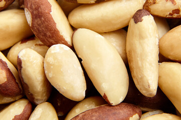 Fototapeta premium Brazil nuts texture background closeup. Shelled nuts, top view. Brazilian nuts, a culinary treasure