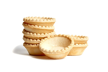 Unfilled tartlet shells isolated on white background. Stacked group of empty mini tart cups for portable desserts. Tartlet shells awaiting sweet or savory fillings