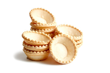 Unfilled tartlet shells isolated on white background. Stacked group of empty mini tart cups for portable desserts. Tartlet shells, an open invitation to gastronomic creativity