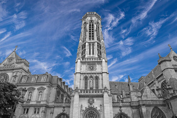 Fototapeta na wymiar Great gothic church of Saint Germain l Auxerrois (against the background of sky with clouds), Paris, France
