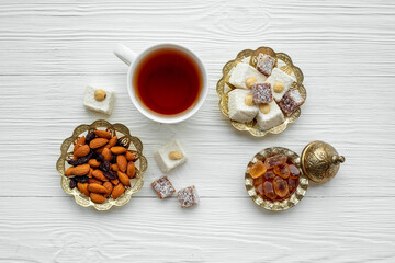 Ramadan party table with tea and sweets. Muslim holiday background