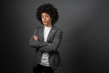 Man in grey elegant jacket standing with crossed arms