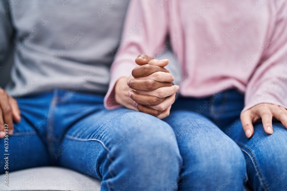 Sticker man and woman couple sitting on sofa with hands together at home