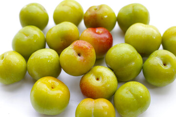 Fresh green plum on white background