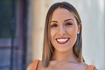 Young beautiful hispanic woman smiling confident standing at street