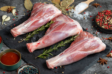 Lamb shank. Raw lamb shank meat on dark background. Butcher products. Close up