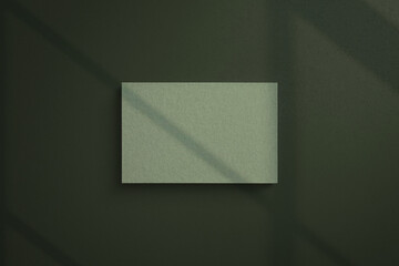 Green color business card mock-up of paper material on window shadow background