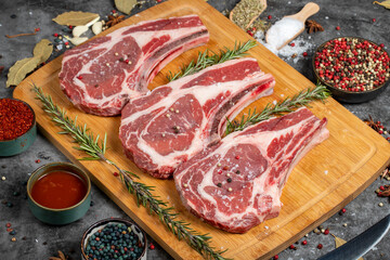 Veal rib boned raw chops. Raw veal cutlet on dark background. Butcher products