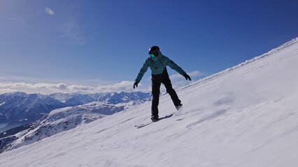 Snowboarder on piste in high mountains, freeze motion