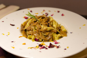 Pasta with mushrooms romantically served on a plate, a beautiful view of a delicious meal