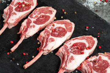 Lamb chops. Fresh raw lamb chops on dark background. Butcher products. Close up