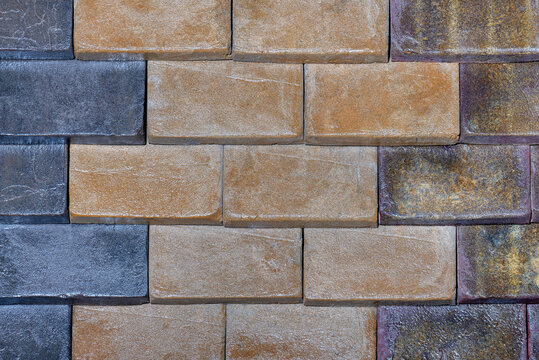 The stone wall is lined with decorative rectangular blocks with different colors.