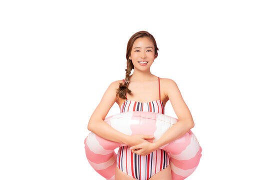 Summer portrait happy young asian woman Happy young woman wear swimsuit hold pink swim ring or inflatable tube ring Excited lady smile and loook at camera isolated on pink color background studio sh