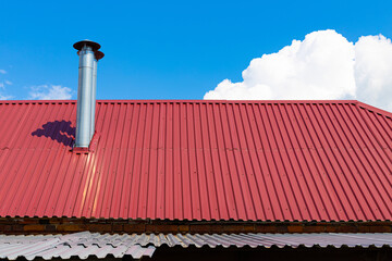 roof of a house with a chimney against the sky