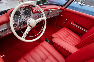 Interior of a classic vintage car, red leather. - 637386231