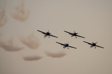Four airplanes in formation on airshow. Aerobatic team performs flight at air show - Powered by Adobe