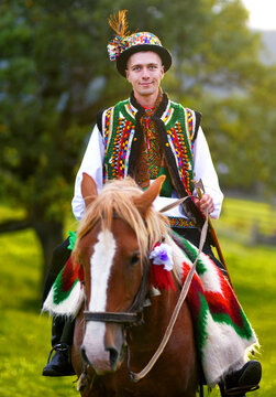 A Ukrainian Hutsul in traditional clothes rides a horse

