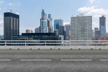 Empty urban asphalt road exterior with city buildings background. New modern highway concrete construction. Concept way to success. Transportation logistic industry fast delivery. Philadelphia. USA.