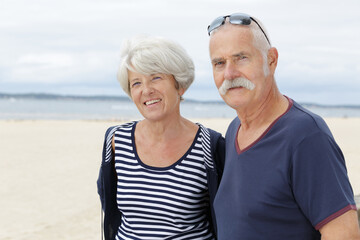 affectionate senior couple on a beach holiday