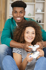 multi ethnic couple playing computer game