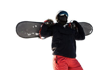 A male snowboarder in equipment and helmet, warm winter sports clothes, holds a snowboard in his...