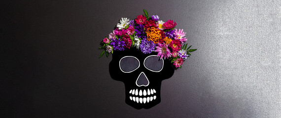 Paper human skull for Mexico's Day of the Dead (El Dia de Muertos) with traditional flowers