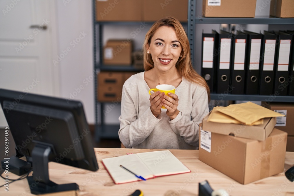 Wall mural young woman ecommerce busines worker drinking coffee at office