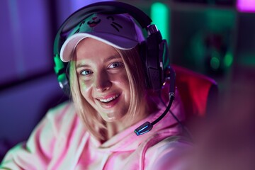 Young blonde woman streamer make selfie by camera at gaming room