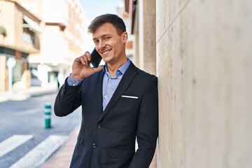 Young man business worker smiling confident talking on smartphone at street