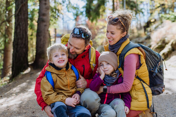 Happy family hiking together in autumn mountains.