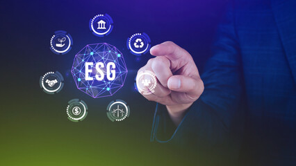 ESG icon concept in the hand for environmental, social and governance in sustainable and ethical business on the Network connection, businessman pressing button on screen.