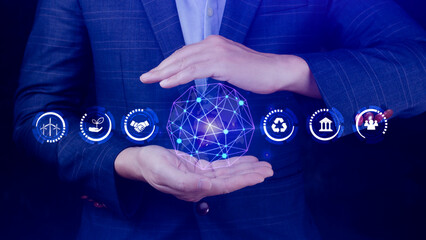 ESG icon concept in the hand for environmental, social and governance in sustainable and ethical business on the Network connection, businessman pressing button on screen.