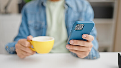 Young caucasian man business worker using smartphone drinking coffee at office