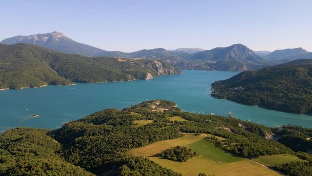 Aerial view of Serre-Poncon lake from Chanteloube Bay to Saint-Michel Bay with Grand Morgon mountain peak. Summer in Durance Valley. Hautes-Alpes (Alps), France