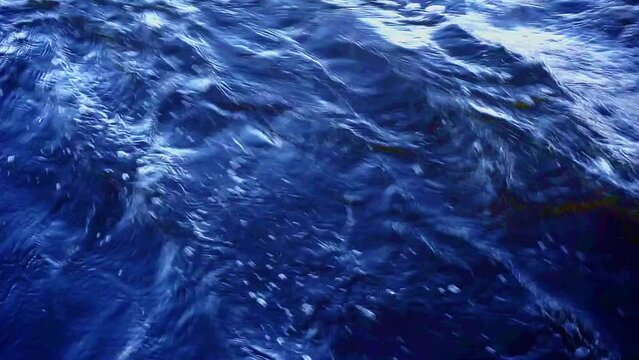 deep blue water surface with waves and ripples background.