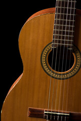 Obraz premium Acoustic guitar on a black background. Musical instrument