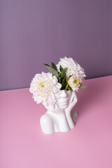 Plaster head with flowers on a colored background. Mental health concept