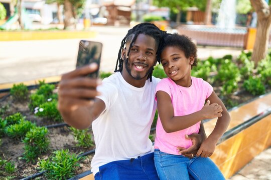 Father and daughter smiling confident make selfie by smartphone at park