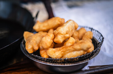 Deep-fried Patongo is a fried Chinese food served with coffee in a market in Yaowarat, Bangkok, Thailand.
