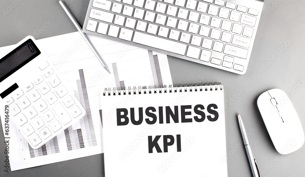 Poster business kpi text written on notebook on grey background with chart and keyboard, business concept
