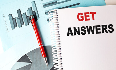 GET ANSWERS text on a notebook with pen on a chart background